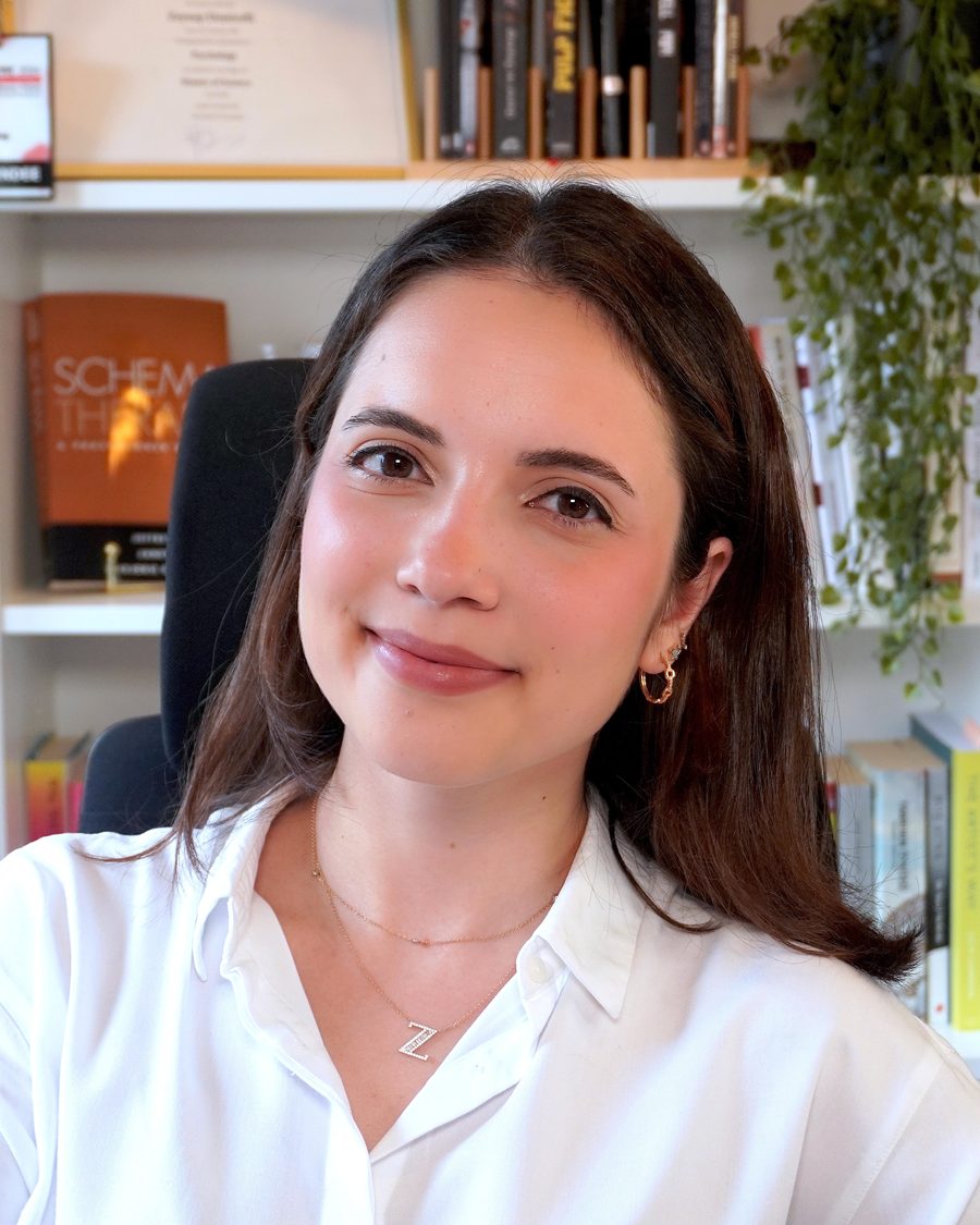 Zeynep Demirelli Sağ, MSc, eating disorder therapist, seated in her study lined with psychology books