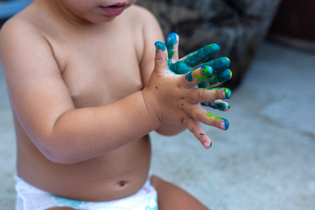 topless child with green manicure