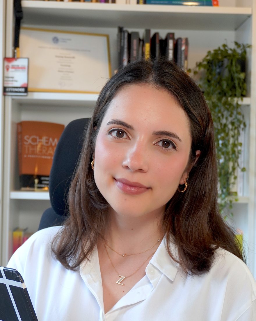 Zeynep Demirelli Sağ, MSc, eating disorder therapist, holding a notebook in her study
